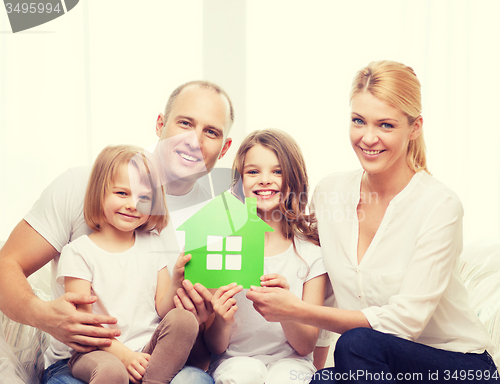 Image of smiling parents and two little girls at new home