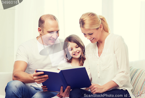 Image of smiling parents and little girl with at home