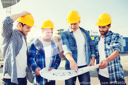 Image of group of builders with tablet pc and blueprint