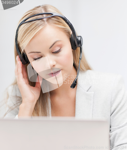 Image of female helpline operator with laptop