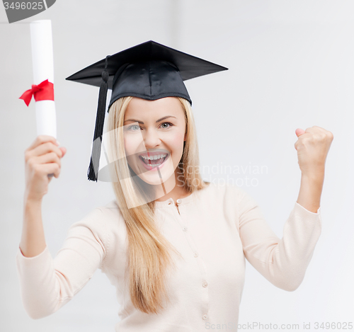 Image of student in graduation cap with certificate