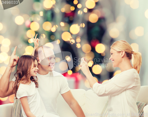 Image of happy family with camera at home