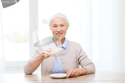 Image of happy senior woman with cup of coffee