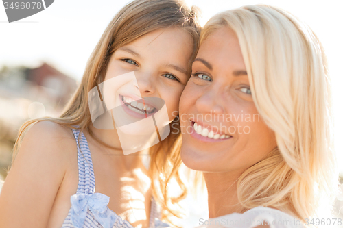 Image of happy mother and child girl outdoors