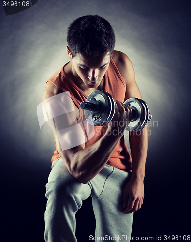 Image of young man with dumbbell