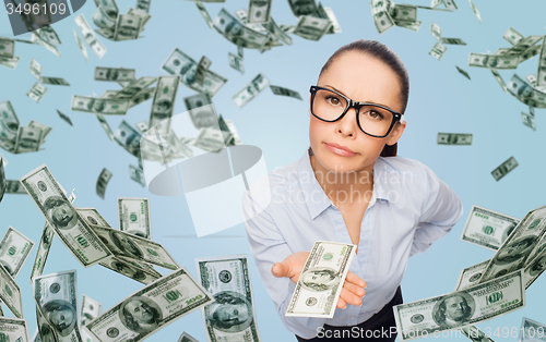 Image of businesswoman with money over blue background