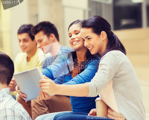 Image of group of smiling students with tablet pc