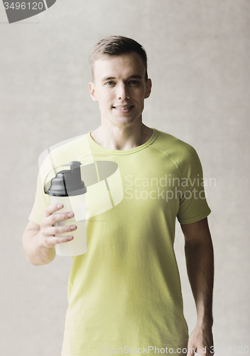 Image of smiling man with protein shake bottle