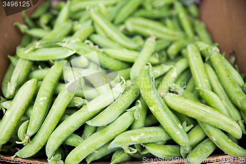 Image of close up of green peas in box at street market