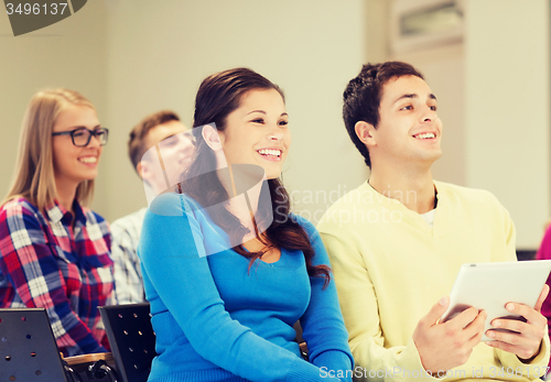 Image of group of smiling students with tablet pc