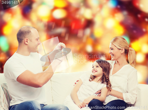 Image of happy family with camera at home