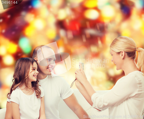 Image of happy family with camera at home