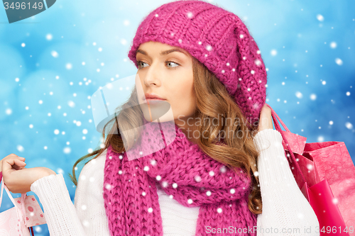 Image of young woman in winter clothes with shopping bags