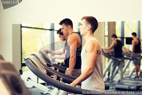 Image of group of men exercising on treadmill in gym