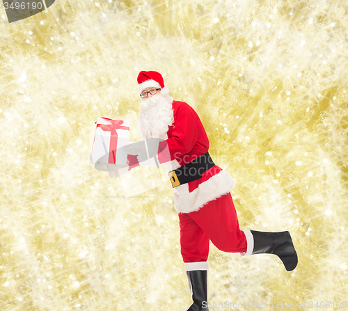 Image of man in costume of santa claus with gift box