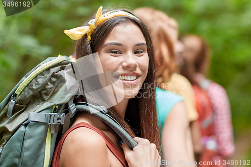 Image of group of smiling friends with backpacks hiking