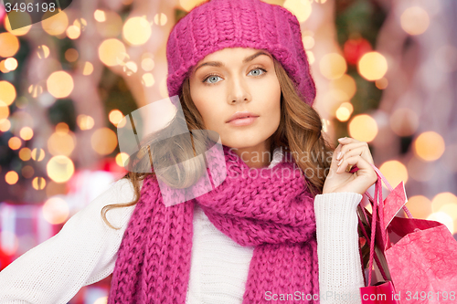 Image of young woman in winter clothes with shopping bags