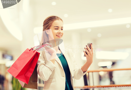 Image of woman with smartphone shopping and taking selfie