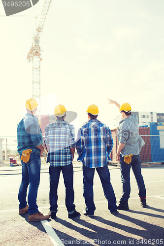 Image of group of builders in hardhats outdoors