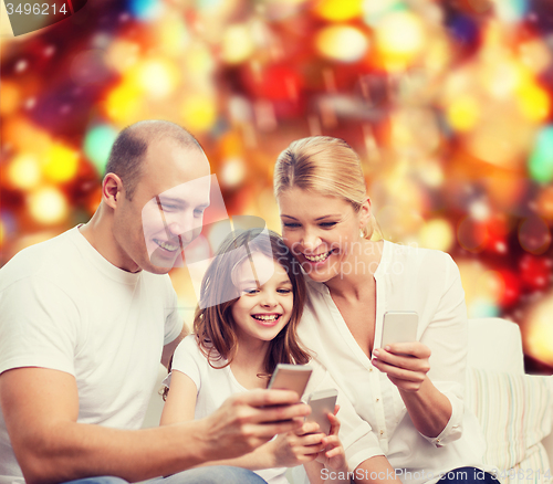Image of happy family with smartphones
