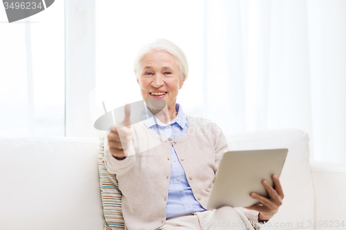 Image of senior woman with tablet pc showing thumbs up 