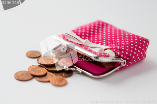 Image of close up of euro coins and wallet on table