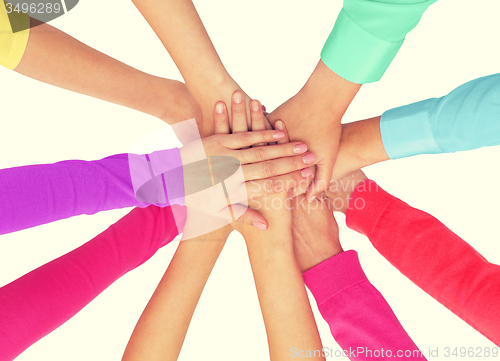 Image of close up of women hands on top in rainbow clothes