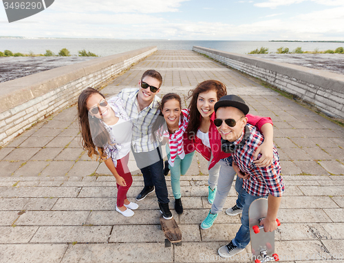 Image of smiling teenagers with skates outside