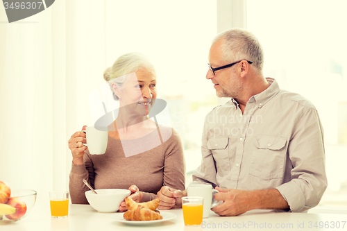 Image of happy senior couple having breakfast at home