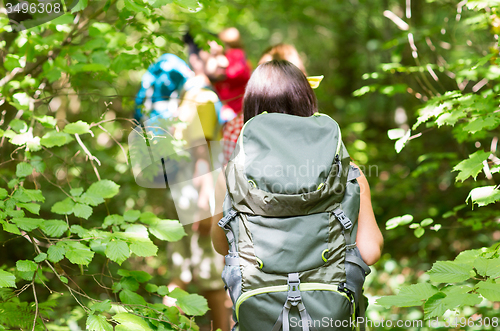 Image of close up of friends with backpacks hiking