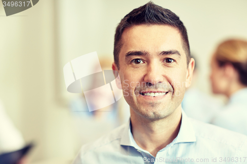 Image of smiling businessman face in office