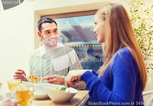 Image of happy couple meeting and having dinner at cafe