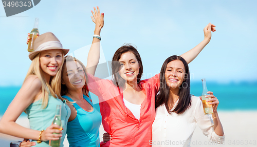 Image of girls with drinks on the beach