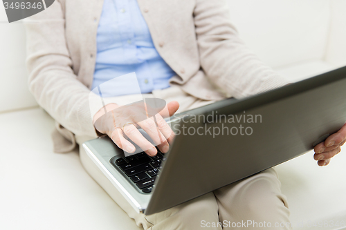 Image of close up of senior woman with laptop at home
