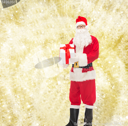 Image of man in costume of santa claus with gift box