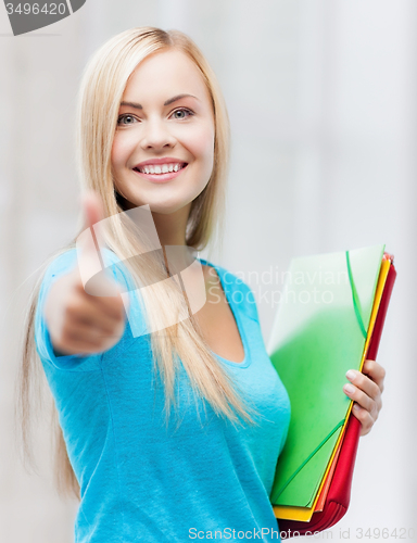 Image of smiling student with folders
