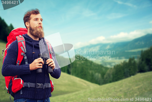 Image of man with backpack and binocular outdoors