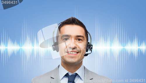 Image of businessman in headset over sound wave or diagram