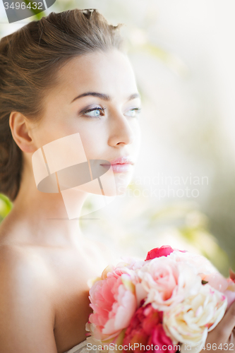 Image of young woman with bouquet of flowers