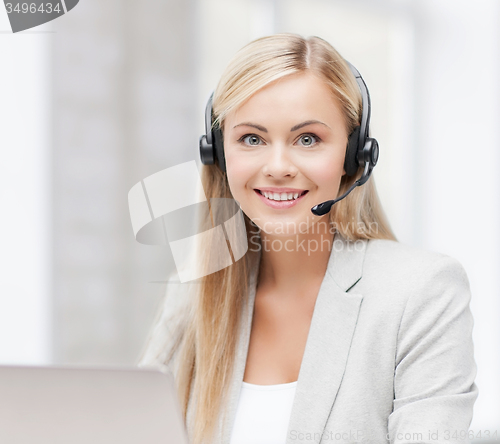 Image of friendly female helpline operator with laptop
