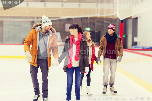 Image of happy friends on skating rink