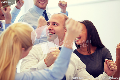 Image of smiling business people meeting in office