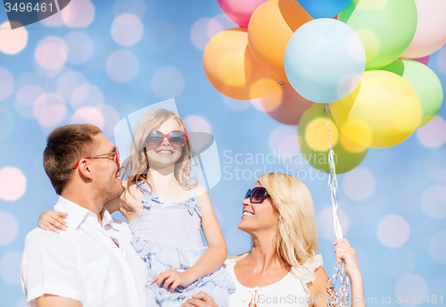 Image of happy family with balloons over blue lights