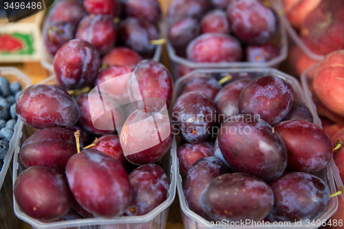Image of close up of satsuma plums at street market