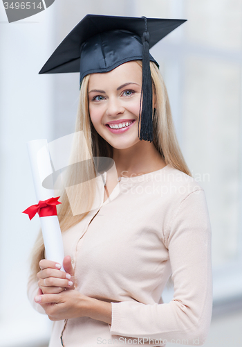 Image of student in graduation cap with certificate