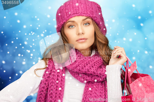Image of young woman in winter clothes with shopping bags