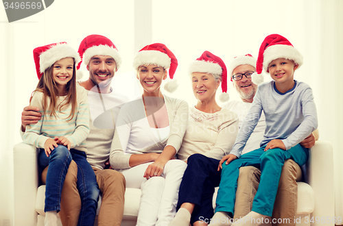 Image of happy family sitting on couch at home