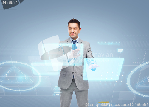 Image of businessman in suit working with virtual screens