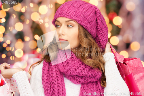 Image of young woman in winter clothes with shopping bags