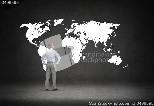 Image of businessman looking at world map